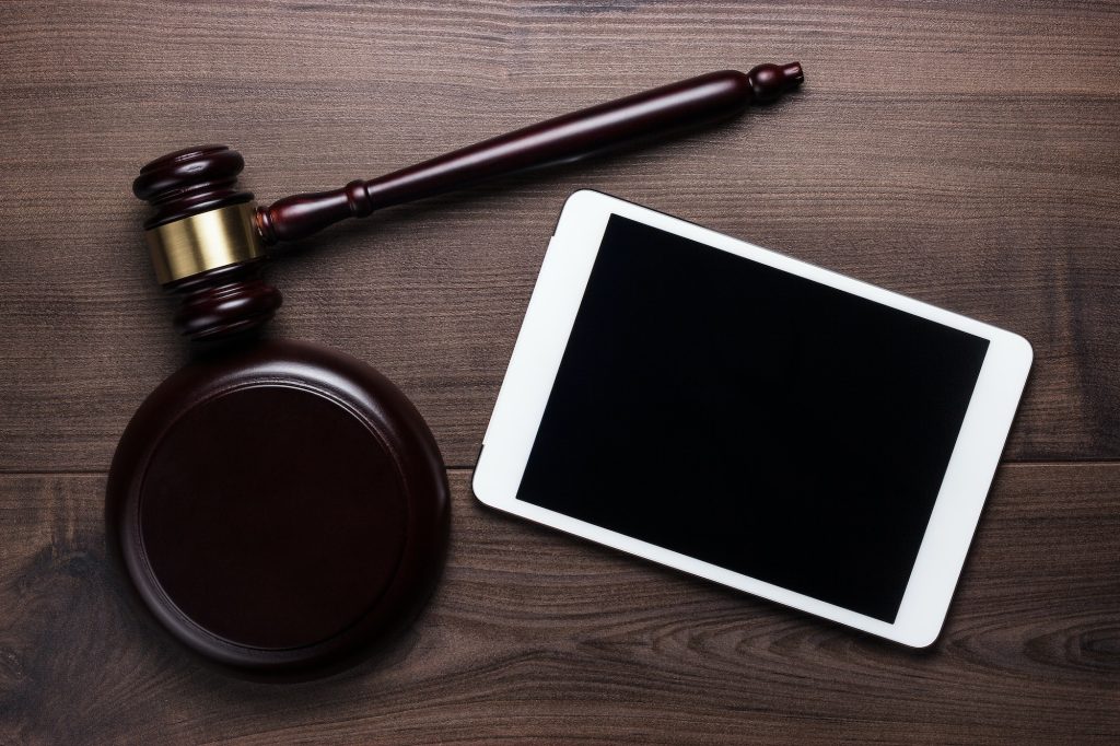 Judge Gavel And Tablet Computer On Brown Wooden Backgroundjudge Gavel And Tablet Computer